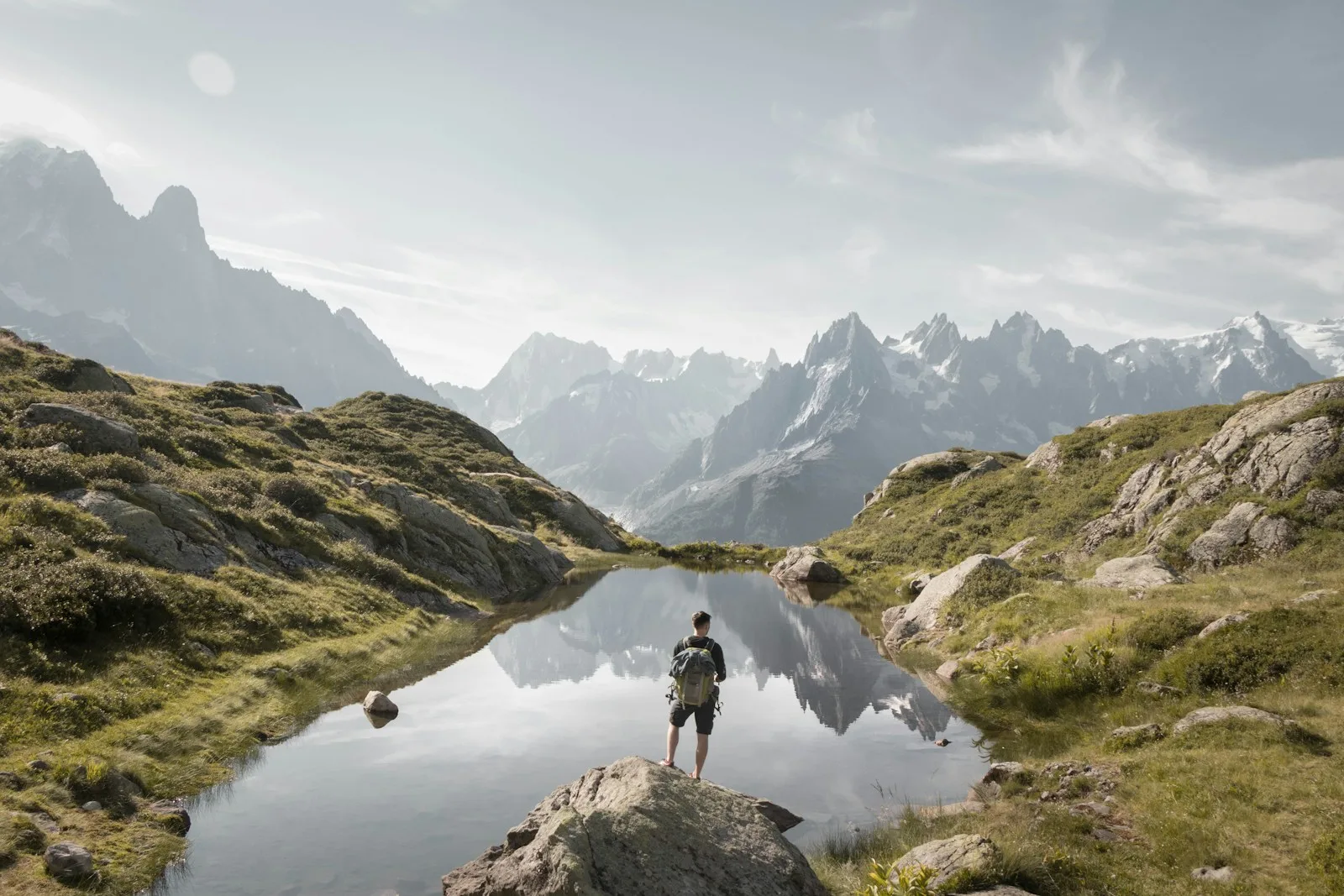 person standing on rock mountain during daytime